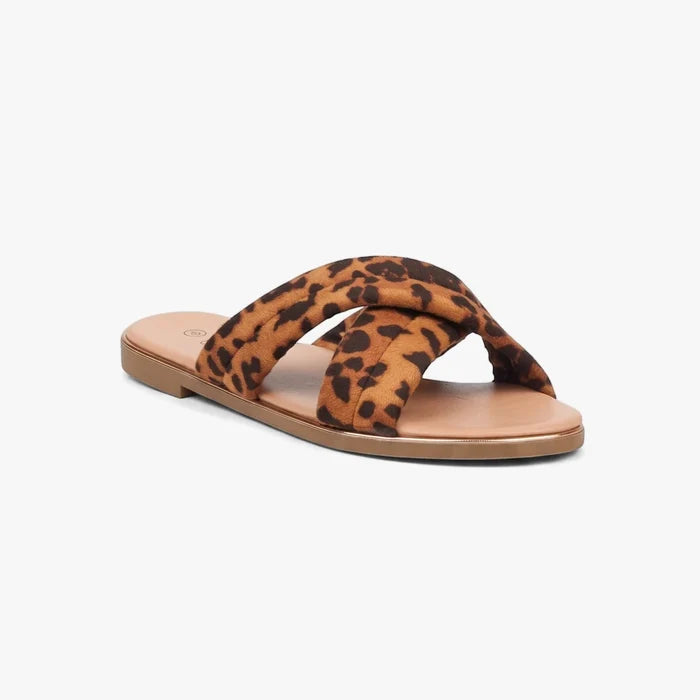 Leopard print women's flat sandal with criss-cross straps, natural sole, and a subtle metallic trim, angled view.