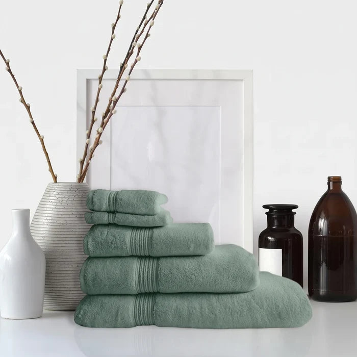 Stack of soft aqua marine Colibri Imperial Zerotwist terry cloth bath towels, neatly folded and arranged.