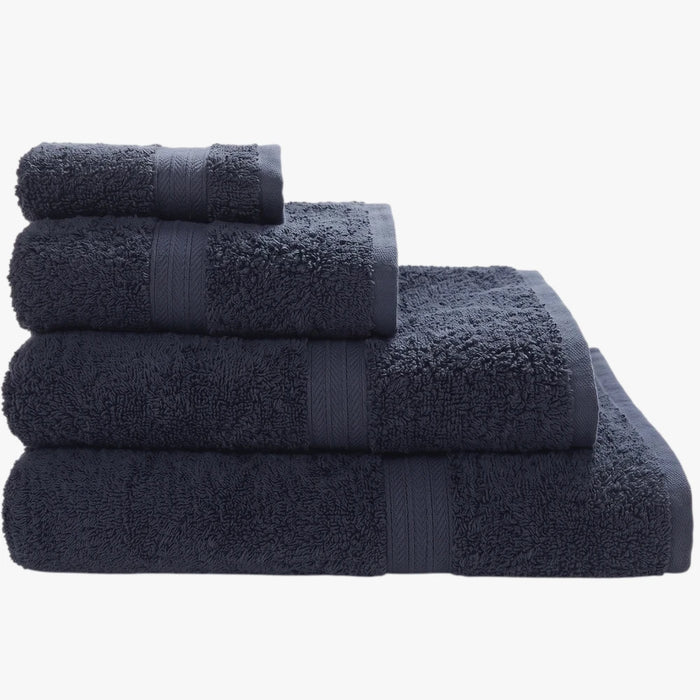 Stack of four folded navy Colibri Imperial Zerotwist bath sheets in varying sizes, showcasing their plush texture.