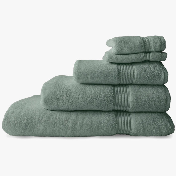 Stack of soft aqua marine Colibri Imperial Zerotwist bath towels, showing varying sizes and ribbed edges.