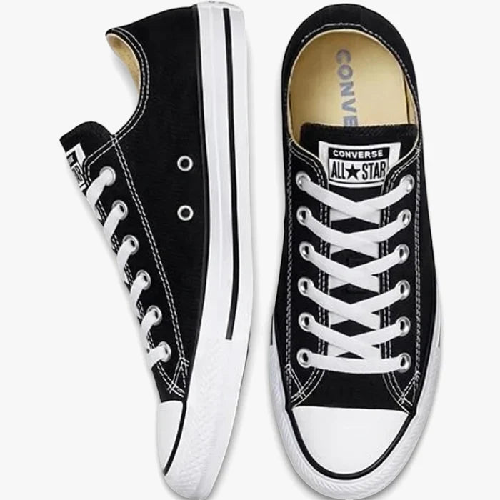 Two black Converse All Star low-top canvas sneakers, one viewed from the side and the other from the top front, featuring