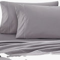 Two grey Cotton Co 400 Thread Oxford 50x90 pillowcases with white stitching, displayed on a matching grey fitted sheet.