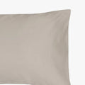 Close-up of a single Cotton Co 400 Thread Oxford pillowcase in a soft stone color, showcasing its smooth fabric texture.