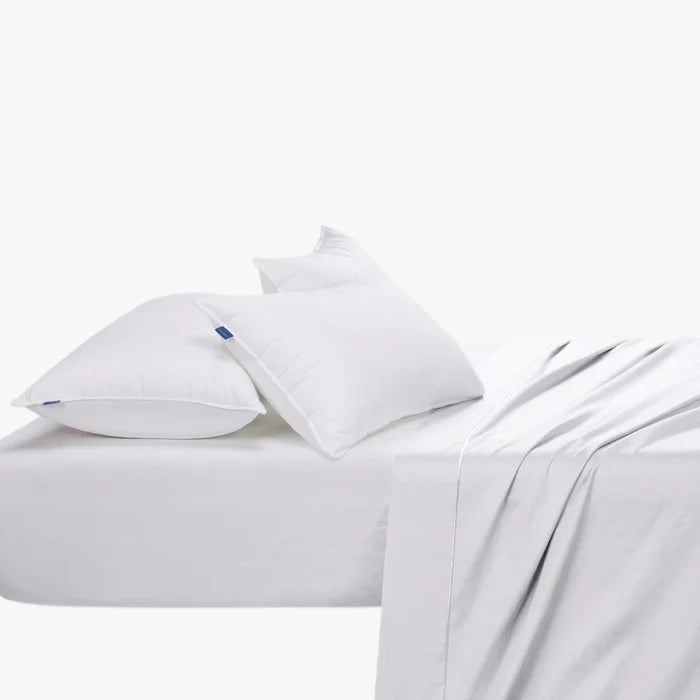 Cotton Co 400 thread count queen extra fitted sheet in white, displayed on a bed with two pillows.