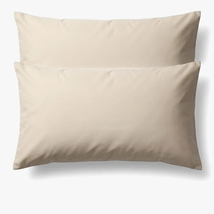 Cream cotton pillowcase from Cotton Co, a standard 45x70 size, shown unfolded and flat on a white background.