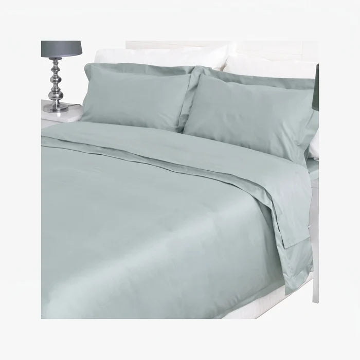 Duck egg blue cotton bedding set featuring a duvet cover and two pillowcases neatly arranged on a bed, shown with a bedside