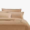Stone Egyptian cotton king duvet cover and matching pillows on a neatly made bed.