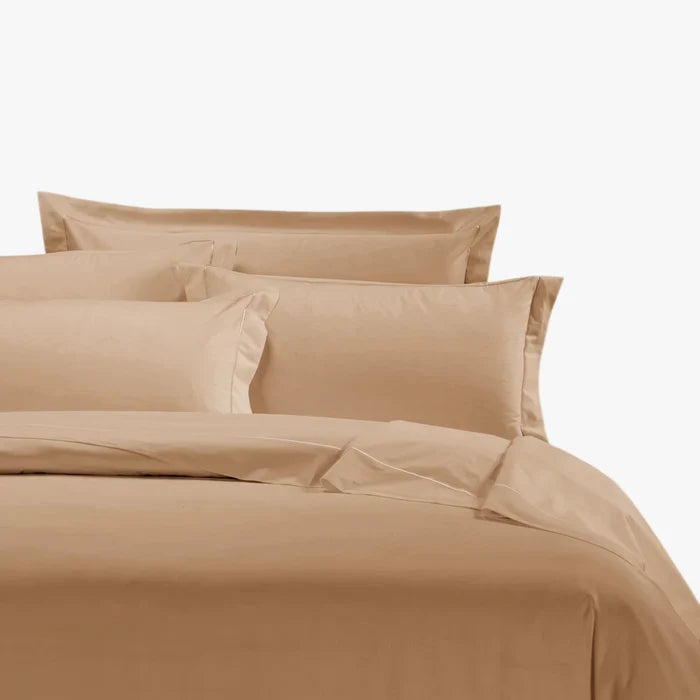 Stone Egyptian cotton king duvet cover and matching pillows on a neatly made bed.