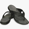 A pair of Crocs Men's Modi Sport Flip Sandals in black with grey footbeds, offering comfortable and casual footwear.