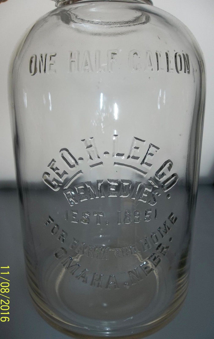 Geo.H.Lee Co. Remedies Glass Jug