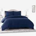 Navy Giorgio Queen Duvet Cover bedding set with two matching pillows, neatly arranged on a bed in a bedroom.
