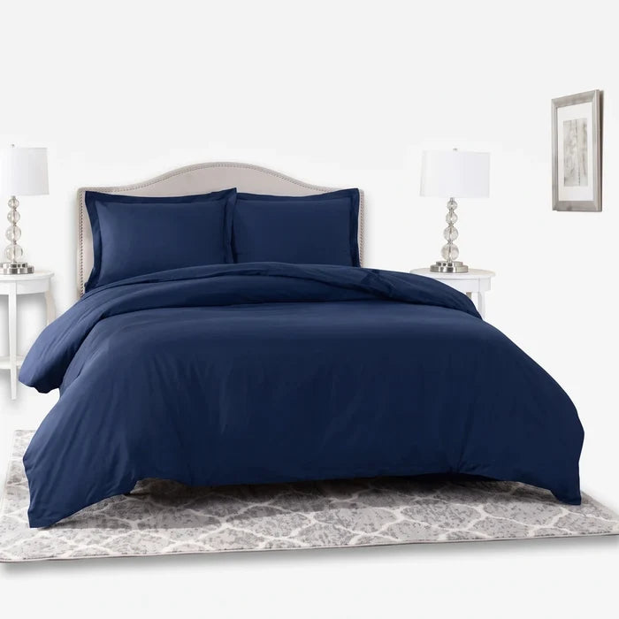Navy Giorgio Queen Duvet Cover bedding set with two matching pillows, neatly arranged on a bed in a bedroom.