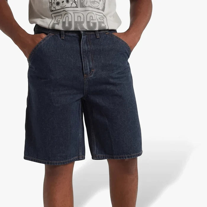 Dark denim Lizzard men's strollers walkshorts, modeled from mid-torso to mid-thigh with hands in pockets.