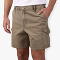 Close-up of a man wearing Lizzard Mens Strollers Walkshort Stone, khaki-colored cargo shorts with a pocket on the side.