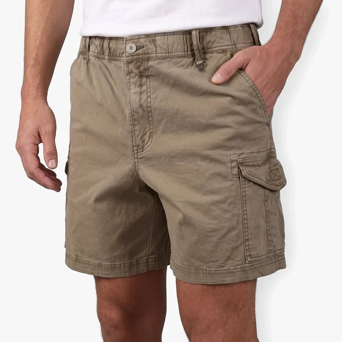 Close-up of a man wearing Lizzard Mens Strollers Walkshort Stone, khaki-colored cargo shorts with a pocket on the side.