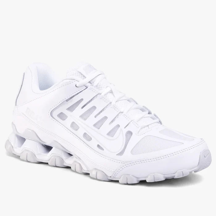 White Nike Men's Reax 8 Mesh Trainer shoe, shown angled from the side, highlighting its mesh upper and cushioned sole.