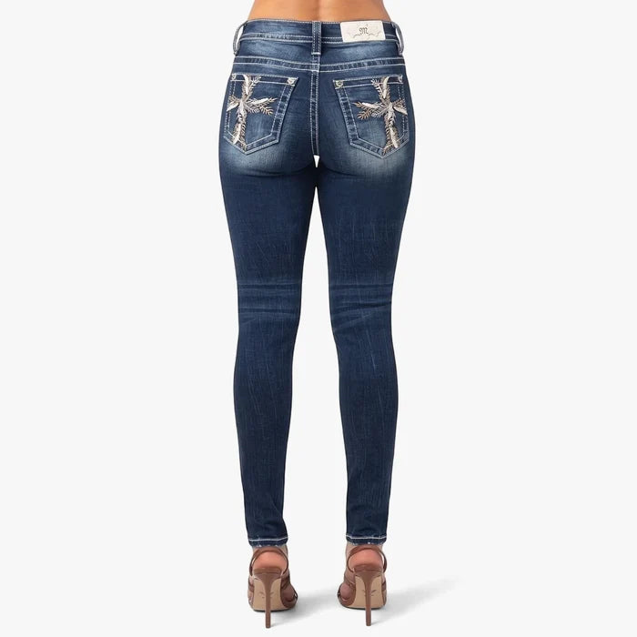 Miss Me Natures Cross Mid Rise Skinny Jeans for women, dark blue wash with rhinestone cross embroidery on back pockets. Rear