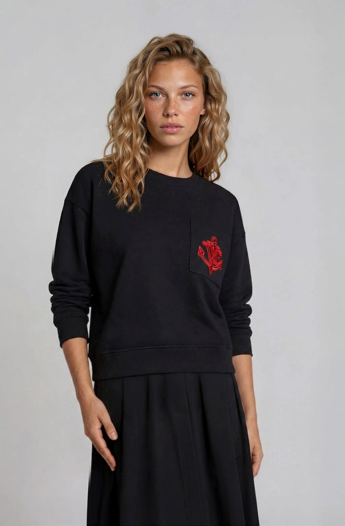Black long sleeve sweatshirt tee top with red embroidered logo motif.