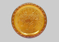 Gold-colored decorative plate with a horse and rider design on a white background