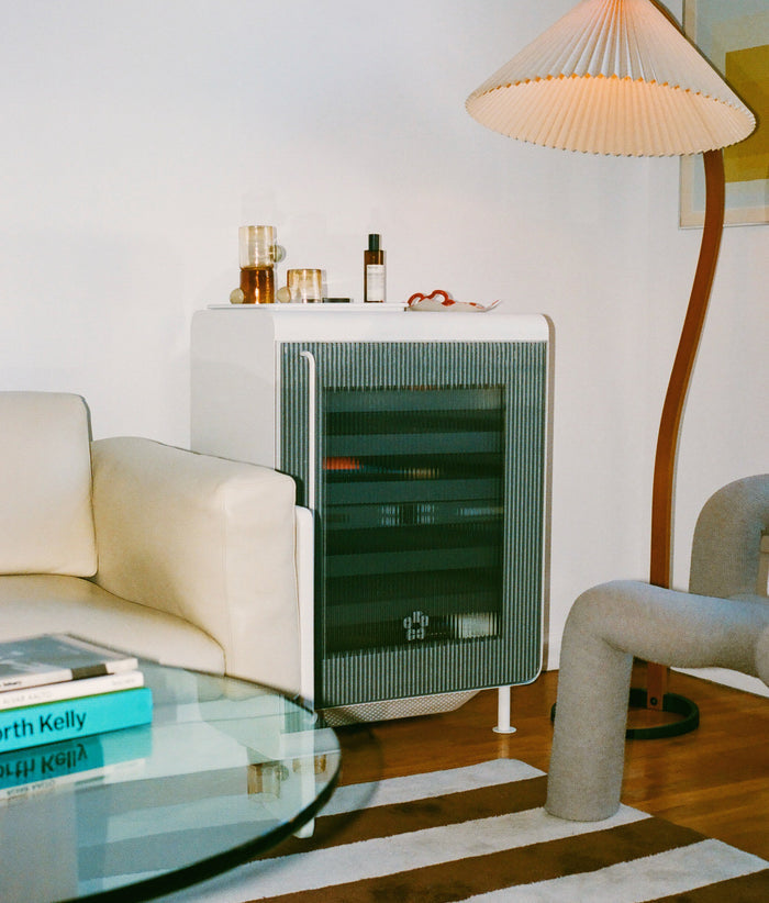 Rocco smart mini fridge in a modern living room, functioning as a stylish white drink fridge or bar cart.