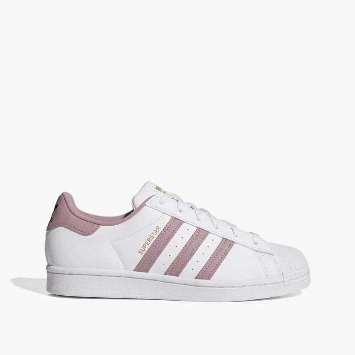 White adidas Women's Superstar sneaker with pink stripes on the side, featuring a classic shell toe and white laces.